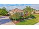 Landscaped front yard with palm trees and driveway at 210 166Th Ne St, Bradenton, FL 34212