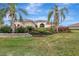 Landscaped front yard with palm trees at 210 166Th Ne St, Bradenton, FL 34212