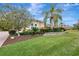 Landscaped yard with tropical plants and a stone wall at 210 166Th Ne St, Bradenton, FL 34212