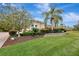 Landscaped yard with tropical plants and a stone wall at 210 166Th Ne St, Bradenton, FL 34212