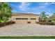 Three-car garage with paver driveway and lush landscaping at 210 166Th Ne St, Bradenton, FL 34212