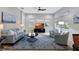 Living room with light gray sofas, coffee table and ceiling fan at 210 166Th Ne St, Bradenton, FL 34212