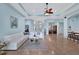 Spacious living room featuring a white sectional sofa and light blue walls at 210 166Th Ne St, Bradenton, FL 34212