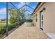 Enjoy this screened patio with pavers, lounge chairs, and serene views at 210 166Th Ne St, Bradenton, FL 34212