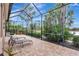 Relaxing screened patio with paver stones and lounge chairs, overlooking lush landscaping at 210 166Th Ne St, Bradenton, FL 34212