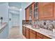 Wet bar with granite countertop and wood cabinets at 210 166Th Ne St, Bradenton, FL 34212