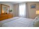 Bedroom with a dresser and a window with curtains at 3223 Beneva Rd # 201, Sarasota, FL 34232