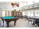 Community room features a pool table, seating areas, and a large bookcase at 3223 Beneva Rd # 201, Sarasota, FL 34232