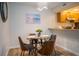 Dining area with glass table, four chairs, and kitchen access at 3223 Beneva Rd # 201, Sarasota, FL 34232