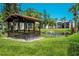 Relaxing gazebo near a pond with lush landscaping at 3223 Beneva Rd # 201, Sarasota, FL 34232