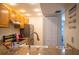 Kitchen with wood cabinets, granite counters, and stainless steel appliances at 3223 Beneva Rd # 201, Sarasota, FL 34232