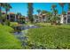 Serene pond with lush greenery and a fountain at 3223 Beneva Rd # 201, Sarasota, FL 34232