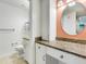 Bathroom with granite countertop and large vanity mirror at 3523 52Nd W Ave, Bradenton, FL 34210