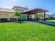 Community clubhouse featuring a covered entrance, lush landscaping, and ample green space at 3523 52Nd W Ave, Bradenton, FL 34210