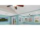 Living room with vaulted ceilings, two ceiling fans, and a view of the golf course at 3523 52Nd W Ave, Bradenton, FL 34210