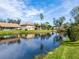 Scenic water view showcasing a tranquil pond reflecting the surrounding community's homes under a sunny sky at 3523 52Nd W Ave, Bradenton, FL 34210