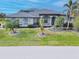 Two-story house with gray exterior and palm trees at 3607 Darin Dr, Punta Gorda, FL 33950