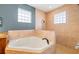 Bathroom featuring a corner soaking tub and a walk-in shower at 3607 Darin Dr, Punta Gorda, FL 33950