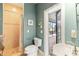Bathroom with shower, toilet, sink, and access to the patio at 3607 Darin Dr, Punta Gorda, FL 33950