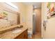 Bathroom with granite vanity, shower, and updated fixtures at 3607 Darin Dr, Punta Gorda, FL 33950