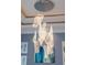 Close-up view of a modern, multi-light glass chandelier at 3607 Darin Dr, Punta Gorda, FL 33950