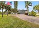 House with palm trees and a paved driveway at 3607 Darin Dr, Punta Gorda, FL 33950