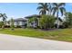 Luxury home with palm trees and manicured lawn at 3607 Darin Dr, Punta Gorda, FL 33950