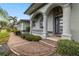 Front entrance with columns, brick walkway, and landscaping at 3607 Darin Dr, Punta Gorda, FL 33950