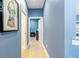 A blue hallway with tile flooring leads to other rooms at 3607 Darin Dr, Punta Gorda, FL 33950