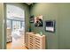 Bright hallway with light wood cabinet and artwork leading to a bedroom at 3607 Darin Dr, Punta Gorda, FL 33950