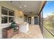 Covered patio with outdoor kitchen, grill, and seating area at 3607 Darin Dr, Punta Gorda, FL 33950