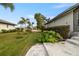 Landscaped side yard with walkway and lush greenery at 3607 Darin Dr, Punta Gorda, FL 33950