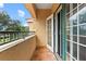 Outdoor balcony with tile flooring and metal railing at 3665 Square West Ln # 13, Sarasota, FL 34238