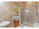 Bathroom features a walk-in shower and bamboo-print wallpaper at 3665 Square West Ln # 13, Sarasota, FL 34238