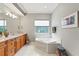 Bathroom with double vanity, corner tub and tile floors at 3665 Square West Ln # 13, Sarasota, FL 34238