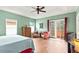 Main bedroom with a ceiling fan and access to a private balcony at 3665 Square West Ln # 13, Sarasota, FL 34238
