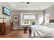 Bedroom with large window, king bed and wood floors at 3665 Square West Ln # 13, Sarasota, FL 34238