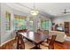 Bright dining room with hardwood floors, a large table, and access to the patio at 3665 Square West Ln # 13, Sarasota, FL 34238