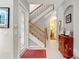 Bright entryway with hardwood floors, staircase, and red rug at 3665 Square West Ln # 13, Sarasota, FL 34238