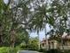Gated community entrance with lush landscaping and Mediterranean style homes at 3665 Square West Ln # 13, Sarasota, FL 34238