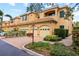 Tan two-story townhome with two-car garage, mailbox, and landscaping at 3665 Square West Ln # 13, Sarasota, FL 34238