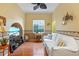 Relaxing Gathering room with hardwood floors, white couch and a large TV at 3665 Square West Ln # 13, Sarasota, FL 34238