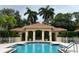 Community pool with surrounding patio area at 3665 Square West Ln # 13, Sarasota, FL 34238