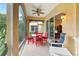 Relaxing screened porch with seating for four at 3665 Square West Ln # 13, Sarasota, FL 34238