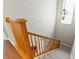 Elegant wooden staircase with a grey carpet runner at 3665 Square West Ln # 13, Sarasota, FL 34238