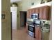 Bright kitchen with stainless steel appliances and light wood cabinets at 4220 Pinebrook Cir # 12, Bradenton, FL 34209