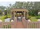 Wooden walkway to a cozy community gazebo with string lights at 425 30Th W Ave # C102, Bradenton, FL 34205
