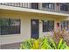 Condo building entrance with private door and tropical plants at 425 30Th W Ave # C102, Bradenton, FL 34205