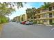 Condo building with parking lot and tropical landscaping at 425 30Th W Ave # C102, Bradenton, FL 34205