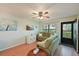 Living room with sectional sofa, hardwood floors, and sliding door at 425 30Th W Ave # C102, Bradenton, FL 34205